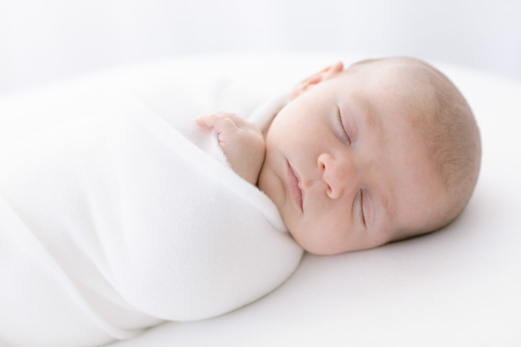 photograph of newborn swaddled and sleeping