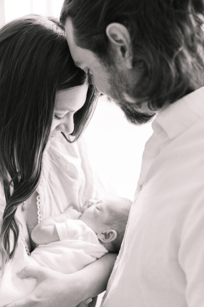 new mom and dad look down at daughter, boston portrait photographer
