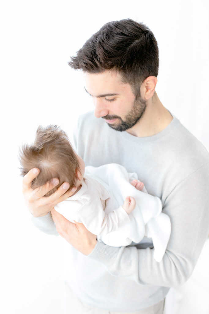 photograph of dad holding baby girl close