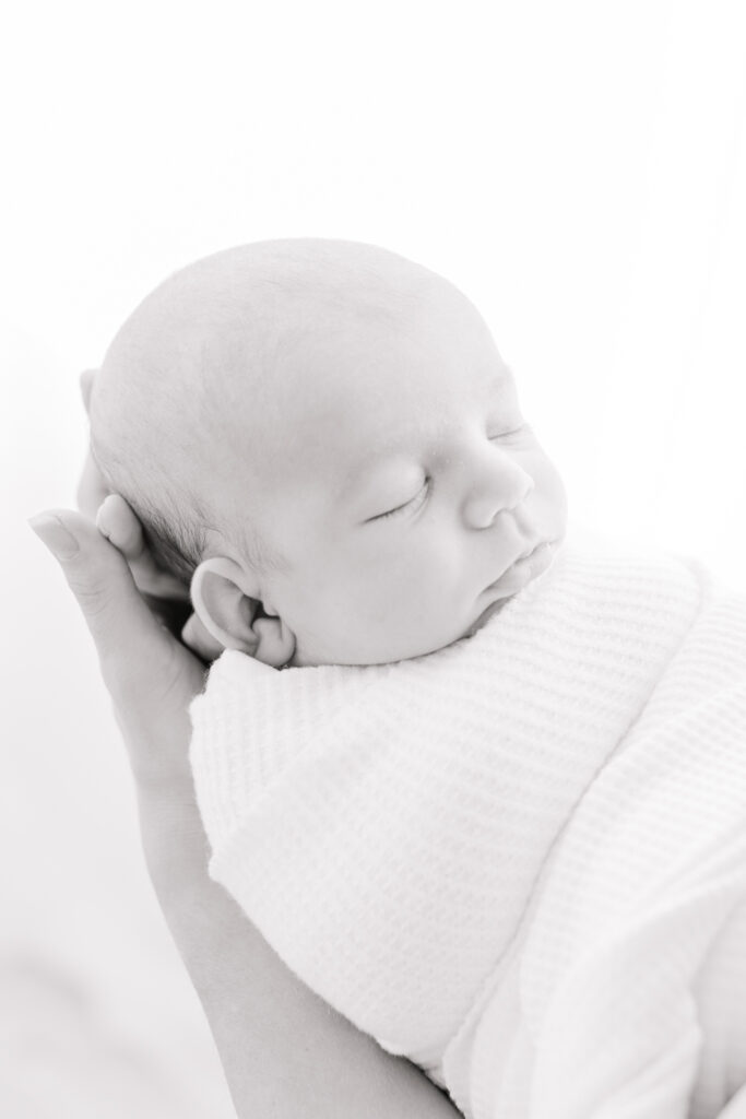 newborn baby wrapped up and sleeping