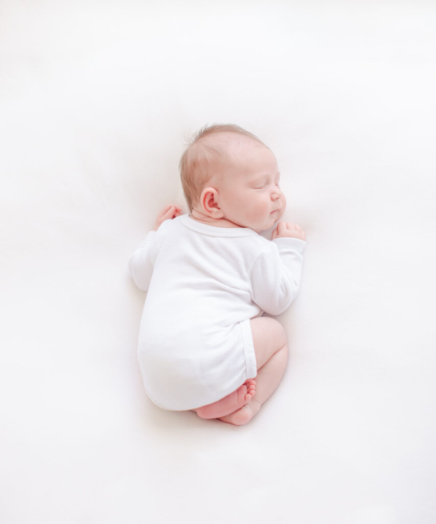 newborn baby in simple hospital onesie