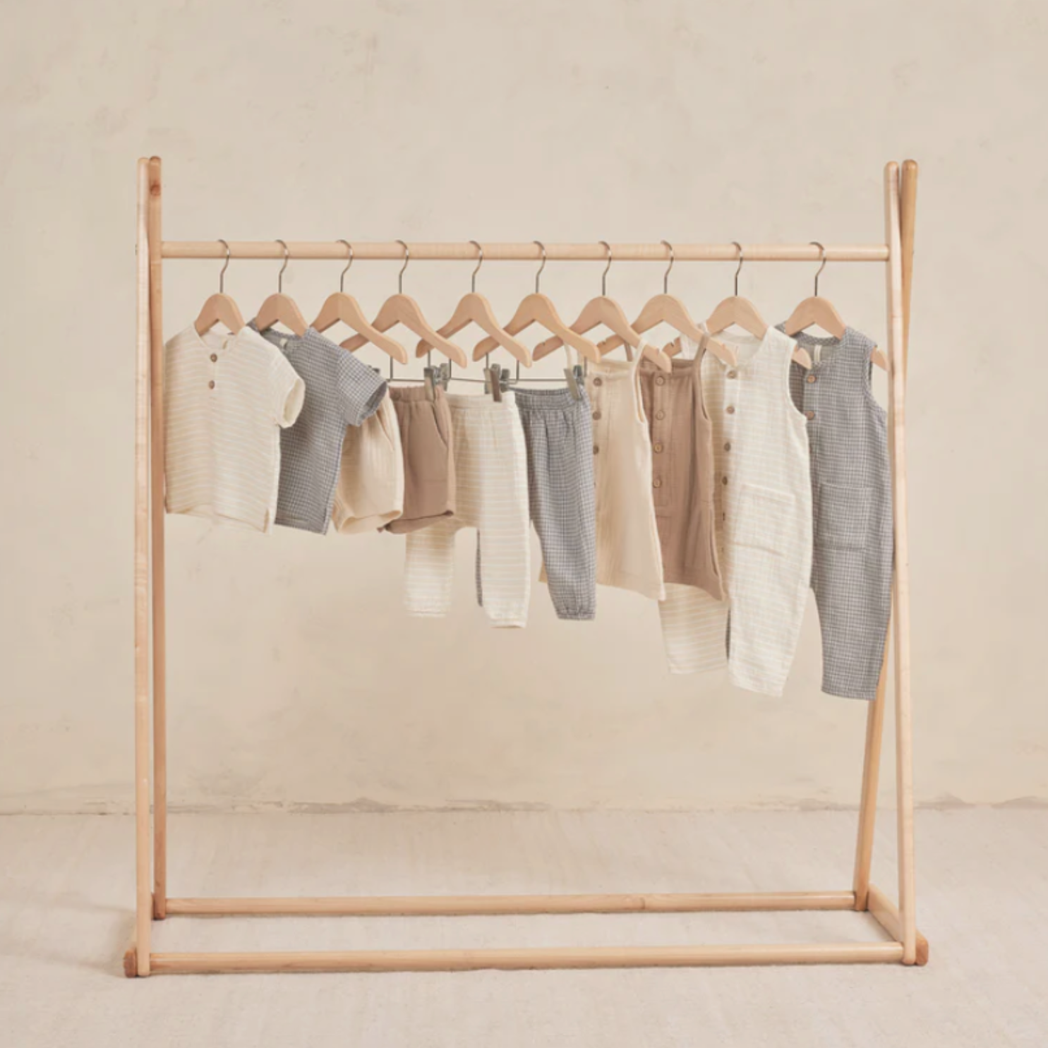 collection of baby clothes hanging in wardrobe