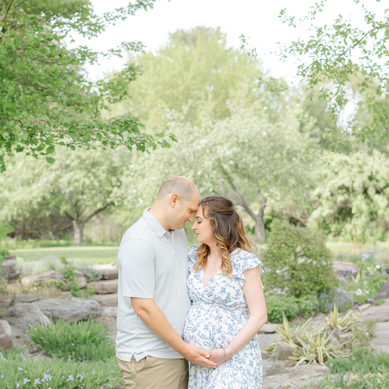 couple poses at the acton arboretum in massachusetts during maternity photoshoot