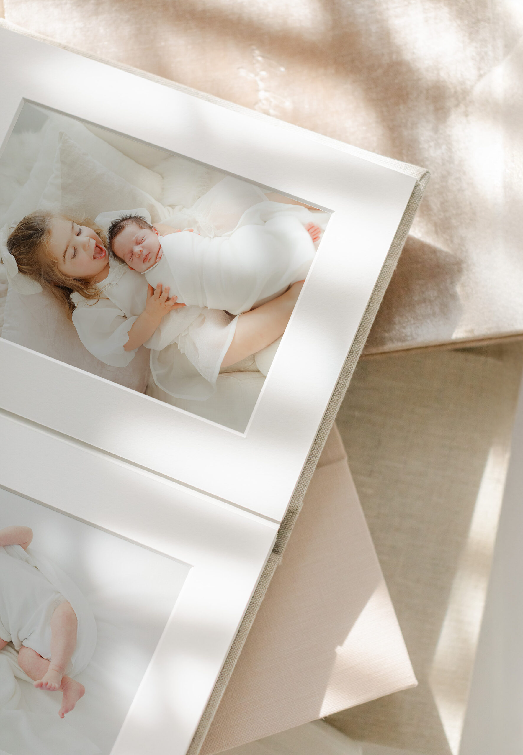 newborn photos in a matted photo album