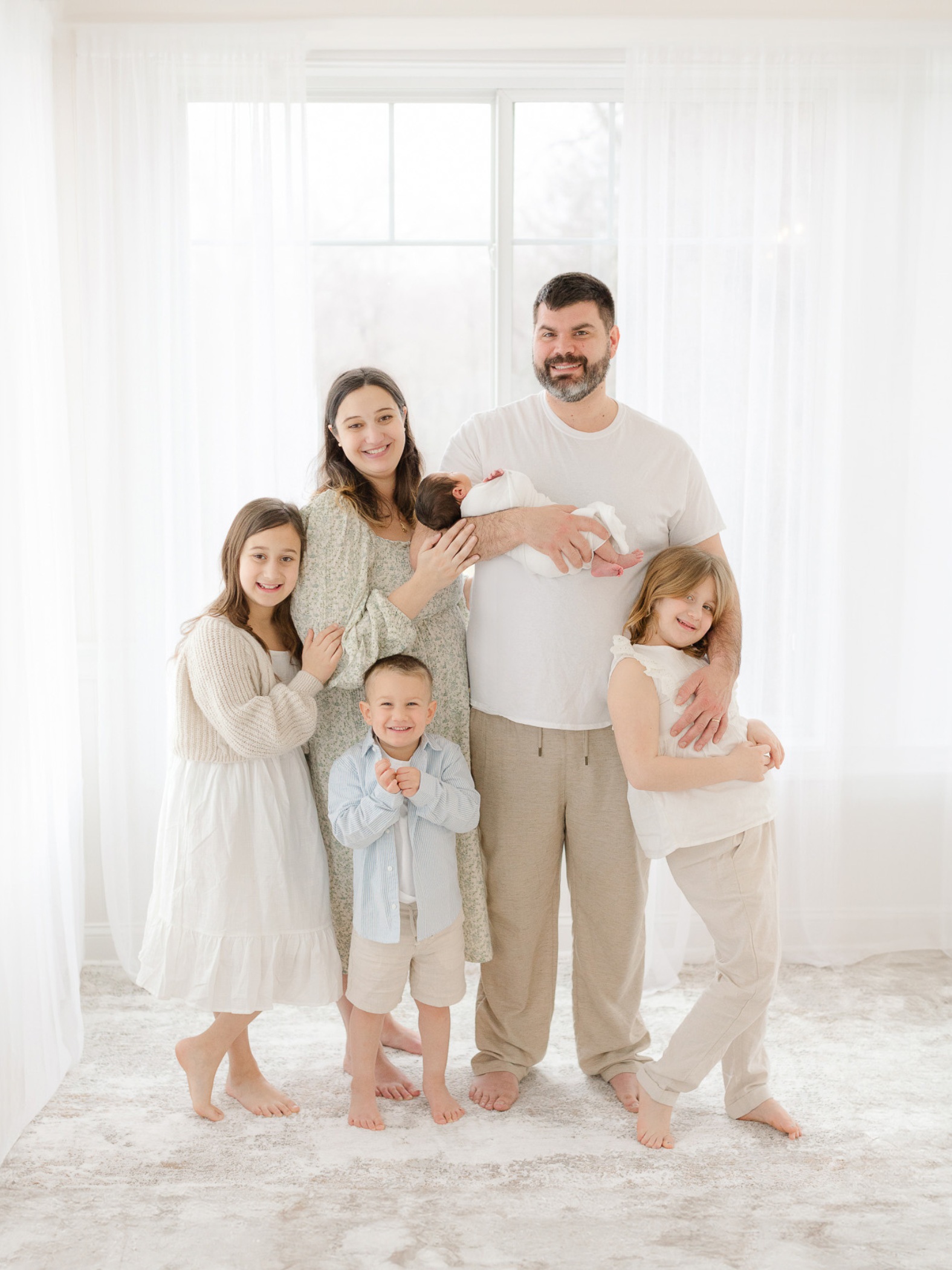 family of six smiles during newborn photoshoot with metrowest boston photographer molly katherine photography